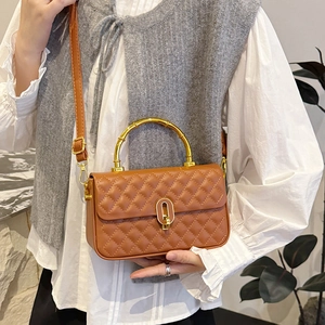 Brown quilted crossbody bag with gold bamboo handle and metallic twist-lock closure