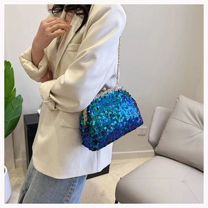 Detail of blue-green gradient sequin shell clutch bag with silver metal chain strap