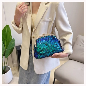 Close-up of glitter sequins and rhinestone clasp on a green shell evening bag