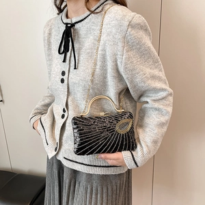 Black sequin evening clutch bag with gold handle and chain strap for women