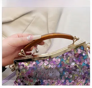 Dettaglio borsa da sera con paillettes, manico in ambra e finiture in oro lucido