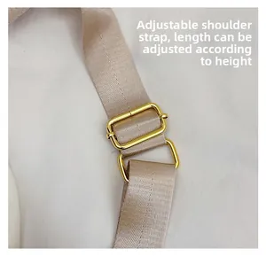 Detail of adjustable champagne strap with golden buckle for large capacity tote bag