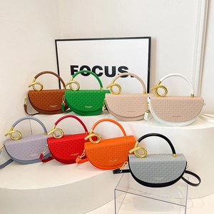 Fashionable half-round saddle bags with gold ring handles and geometric embossing