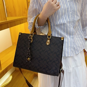 Classic coffee tote bag with vintage monogram pattern and stylish fringe detail for women