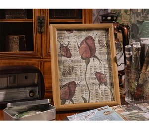 Detail of vintage wooden frame featuring red rose and sheet music for home decor