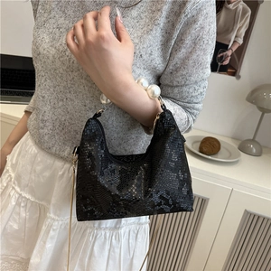 Elegant black snake-pattern handbag with pearl handle and golden chain strap