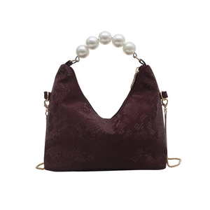 Burgundy snakeskin embossed handbag with oversized pearl handle and gold chain strap