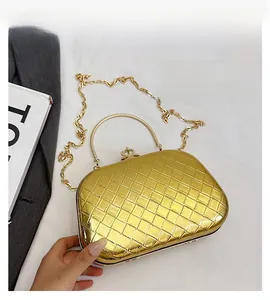 Detailed view of gold metallic woven evening clutch with semi-circular handle and chain