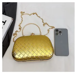 Detail of woven metallic evening bag with chain strap and round metal handle