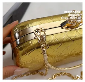 Detailed close-up of golden woven texture evening bag with detachable metal chain strap