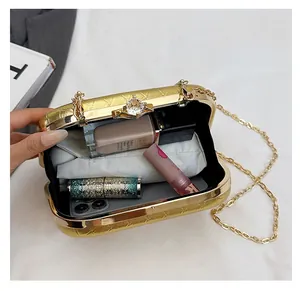 Internal view of gold textured clutch bag showing capacity for phone and cosmetics