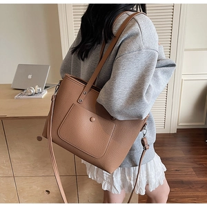 Brown lychee texture tote bag detail showing spacious main pocket and magnetic front pouch