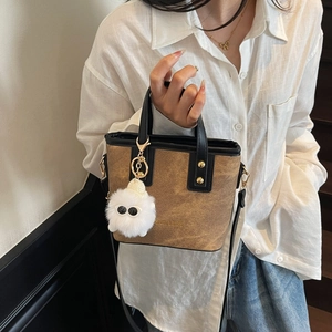 Vintage brown canvas bucket bag with black leather trim and cute monster plush pendant