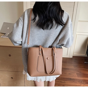 Deep brown lychee pattern leather tote bag styled with casual grey sweatshirt