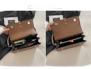 Detail view of the brown shoulder bag's internal compartments and magnetic closure