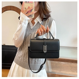 Chic black rectangular handbag featuring silver metal clasp and detachable strap detail