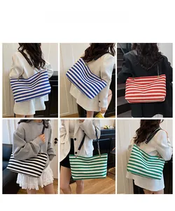 Showcase of striped canvas tote bags in various colors worn by a model in a home setting