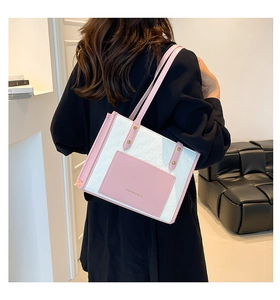 Detail of pink and white tote bag featuring gold rivets and Fashion & Bags text logo