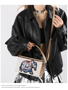 Detail of embroidered elephant bag showing premium textures and the adjustable strap