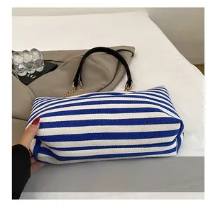 Macro detail of the reinforced wide bottom on blue and white striped tote bag