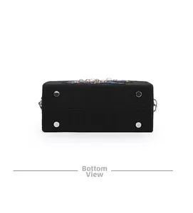 Bottom view of embroidered elephant clutch showing protective metal feet and fabric texture