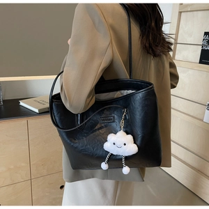 Black PU leather tote bag with cloud charm pendant and brand label shown on shoulder