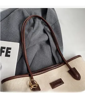 Close-up of durable dual-tone straps and reinforced stitching on a large tote bag