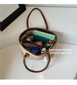 Spacious interior of beige tote bag showing high capacity for tablets and daily essentials