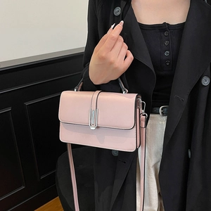 Elegant pale pink square handbag with silver metal buckle and adjustable shoulder strap