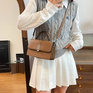 Minimalist caramel brown square handbag in matte leather with top handle and crossbody strap