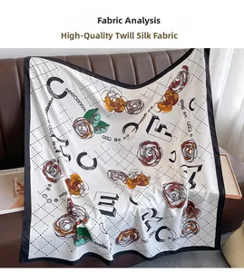 Detailed view of white twill silk scarf with floral camellia print and black border