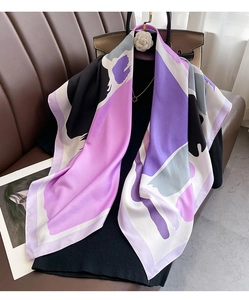 Detailed drape of a silk-satin scarf with abstract purple and black color blocks