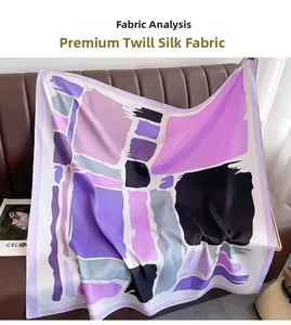 Detail of abstract geometric twill silk scarf draped on leather background with drape texture