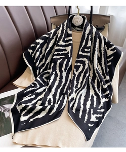 Detailed view of silk texture with black and white abstract zebra pattern on large scarf