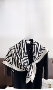 Detail of elegant black and white zebra pattern scarf in smooth satin twill finish