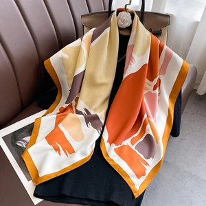 Detail of silk square scarf showing modern abstract print and smooth satin texture