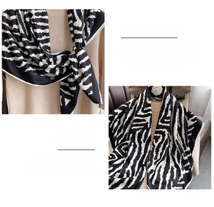 Detailed view of black and white zebra pattern scarf with premium stitched edge craft