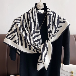 Fashionable zebra print large square scarf with silky texture draped on a hanger