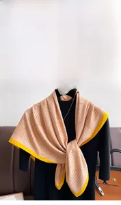 Detail of a modern geometric line pattern on a peach and yellow silk scarf for women