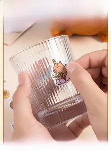 Close-up of cute waterproof Capybara stickers decorated on a glass cup surface