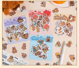 Detailed view of four colorful Capybara cartoon sticker packs including 40 pieces each set