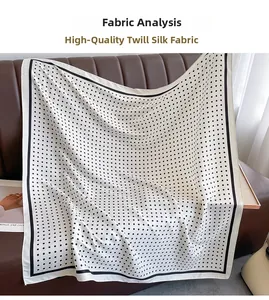 Detail of high-quality twill silk fabric with black polka dots on cream background