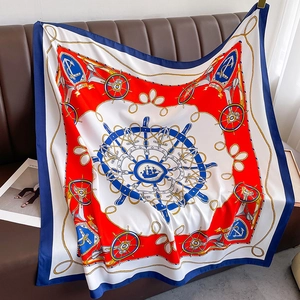 Detail of a large square silk scarf featuring a nautical navy helm and anchor pattern