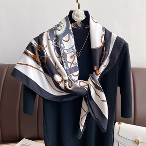 Elegant nautical silk scarf with anchor print in black white and gold draped on a model