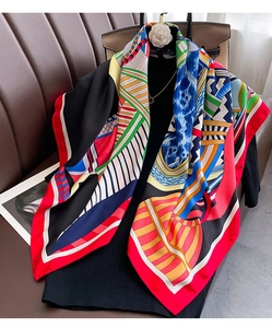 Detail of a large geometric silk scarf on a mannequin with modern colorful patterns