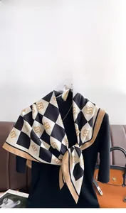 Detail of checkered twill silk scarf with vintage monogram pattern for women