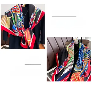Detailed close-up showing the hemmed edge and colorful geometric pattern of the large silk scarf