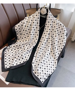 Polka dot silk scarf styled with luxury accessories and camellia flower detail
