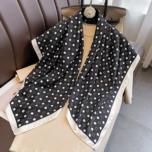Polka dot silk scarf in black and white with satin finish for sun protection and beachwear