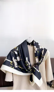 Detailed macro view of the premium silk scarf featuring elegant magnolia floral patterns